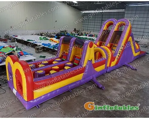 Purple dual lane obstacle course with pool